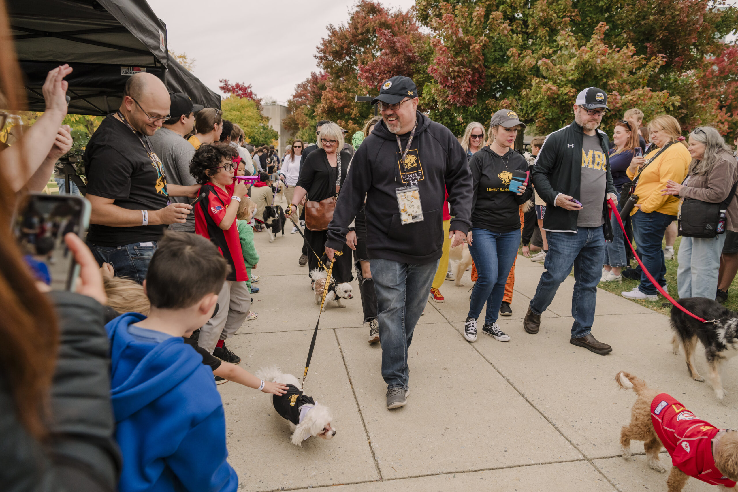 Provost Manfred van Dulmen and others participate in the 2024 Puppy Parade on the UMBC campus.